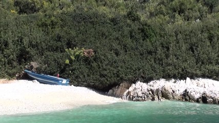 Blue boat with Turkish flag on a sea beach 