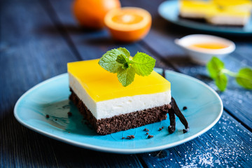 Chocolate cake bars with mascarpone layer and orange jelly topping