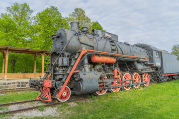 Naklejka premium Old steam locomotive train under blue sky