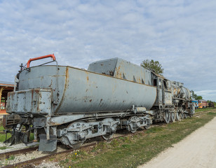 Fototapeta na wymiar Old steam locomotive train under blue sky