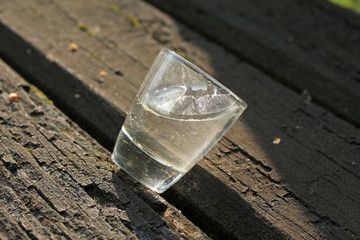 small glass of alcohol left on the bench after the party