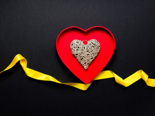 heart shape toy inside box with yellow ribbon