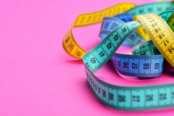 Tapes for measuring in cyan, yellow, blue make chaotic swirl