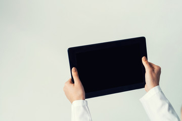 Close of female doctor hands working with tablet pc computer