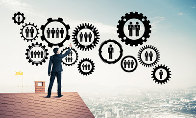 Businessman on house roof presenting teamwork and connection con