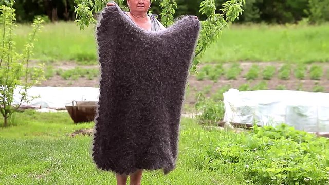 Woman in grey knitted wool shaw smiling. Russia, Urupinsk, national dress.