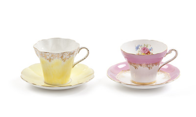 Beautiful vintage tea cups and saucers collection, isolated on a white background.