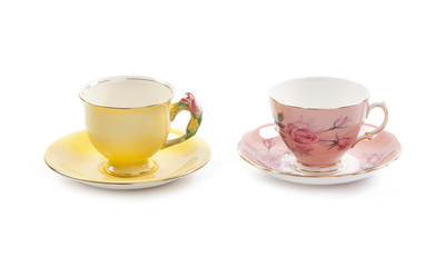 Beautiful vintage tea cups and saucers collection, isolated on a white background.