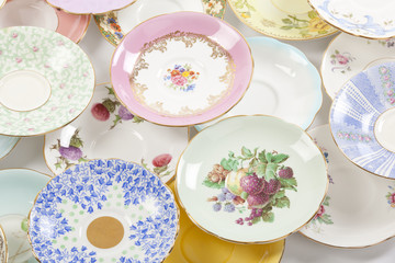 Beautiful vintage tea cups and saucers collection, isolated on a white background.