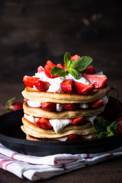 Pancakes cake with mascarpone and strawberries. Dark foto.
