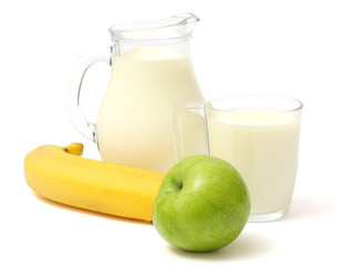 Glass jug pitcher of fresh milk with glass, apple and banana isolated on white background carafe