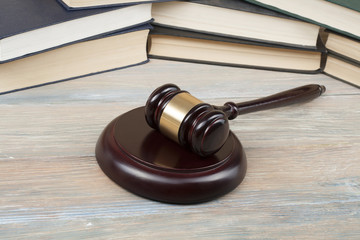 Law concept .Books with wooden judges gavel on table in a courtroom or enforcement office.