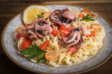 Noodles with seafood on a wooden background