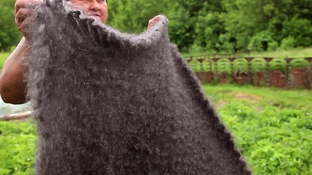 Woman in grey knitted wool shaw smiling. Russia, Urupinsk, national dress.