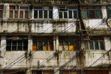 the outer wall of an abandoned old building waiting for redevelopment in Hong Kong