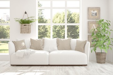 White room with sofa and green landscape in window. Scandinavian interior design. 3D illustration