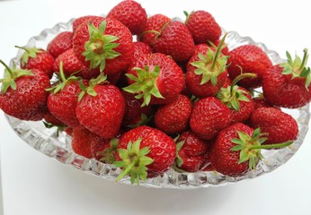 Still life, the crystal vase filled with strawberry