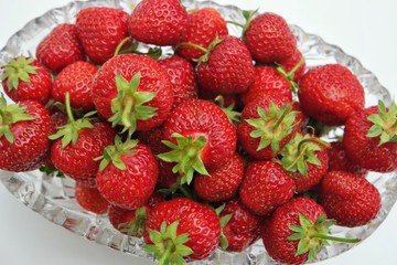 Still life, the crystal vase filled with strawberry