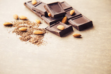 Pieces of dark chocolate with almonds and a grated chocolate crumb