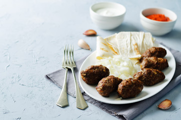 Minced meat sausage with onion, sour cream, pita and red bell pepper relish