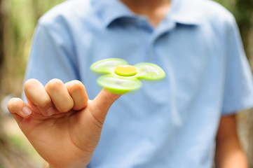 Boy playing with a Tri Fidget Hand Spinner