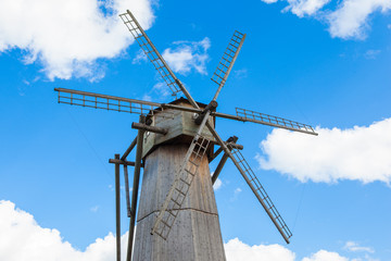 Dutch windmill with blue sky and clouds background