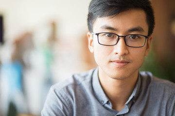 Confident Asian businessman in eyeglasses