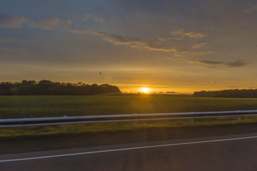Obraz na płótnie Canvas Sunset in field. in motion.