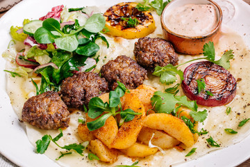 Plate of arabic kebab meat with grilled vegetables