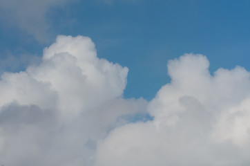 Fluffy,swirling clouds in the blue sky.