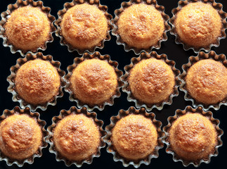 Some cupcakes in the baking dish on a dark background