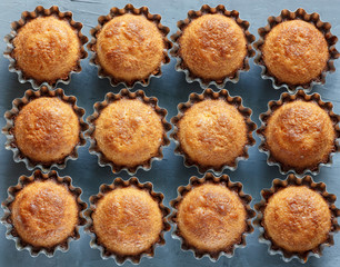 Some cupcakes in the baking dish on a dark background