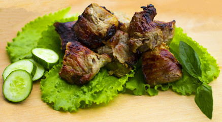 Pork shish kebab on a wooden table