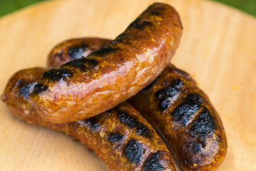 Grilled sausage on a wooden board