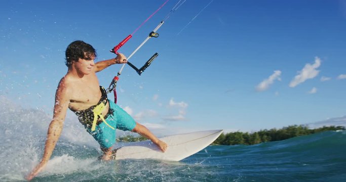 Young Man Kite Surfing in Slow Motion on Surfboard at Sunset in Hawaii