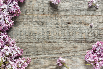 Bouquet of lilac flowers on wooden background.
