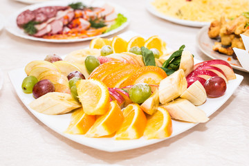delicious fruit table with different sweets, for wedding reception, catering in restaurant.