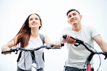 Happy couple riding bicycle outdoors, health lifestyle, fun, love, romance concept