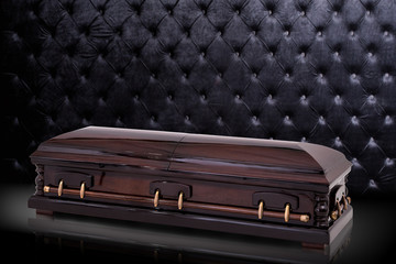 closed wooden brown sarcophagus isolated on gray luxury background. casket, coffin on royal...