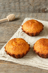 A few muffins in the baking dish. Wooden background.