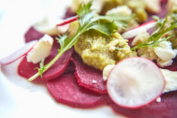 Healthy Beet Salad with fresh sweet baby spinach, kale lettuce, nuts, feta cheese and toast melted. Fresh salad with beets, closeup. Beetroot (beet) chopped for salad in bowl over rustic wooden table.