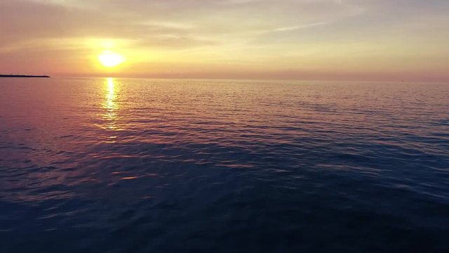 Shot of a beautiful summer sunset at the beach. Sunset at sea drone footage  