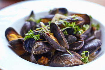 Fresh oyster topped with a spicy sauce vegetable salad. Fresh oysters on a plate.