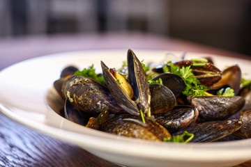 Fresh oyster topped with a spicy sauce vegetable salad. Fresh oysters on a plate.