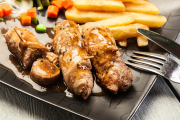 Pork rolls with french fries with vegetable