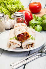 Mexican burritos wraps with mincemeat, beans and vegetables