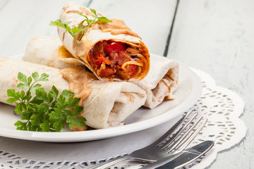 Mexican burritos wraps with mincemeat, beans and vegetables