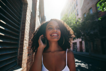 Beautiful african woman walking down the city street