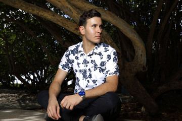 Man sitting on the table and glancing awya from camera