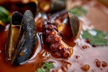 warm salad with chicken liver and grapes on the white plate. Warm salad from turkey liver. Warm salad with chicken liver in raspberry sauce.